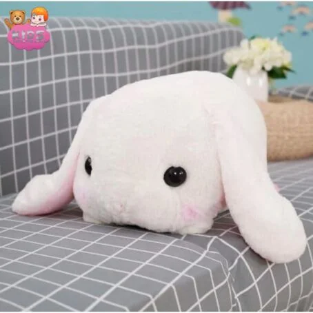 Lapin en peluche blanc couché